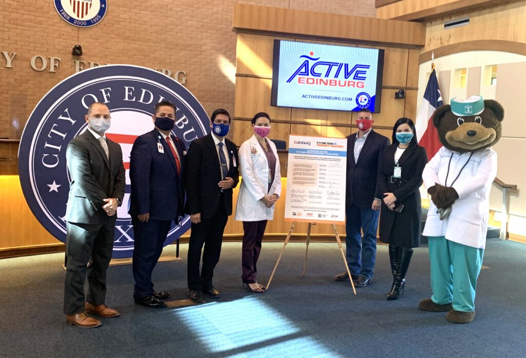 Edinburg Chamber of Commerce Board Member Mario Lizcano, city officials and local health leaders pose for photo during ITT pledge signing.